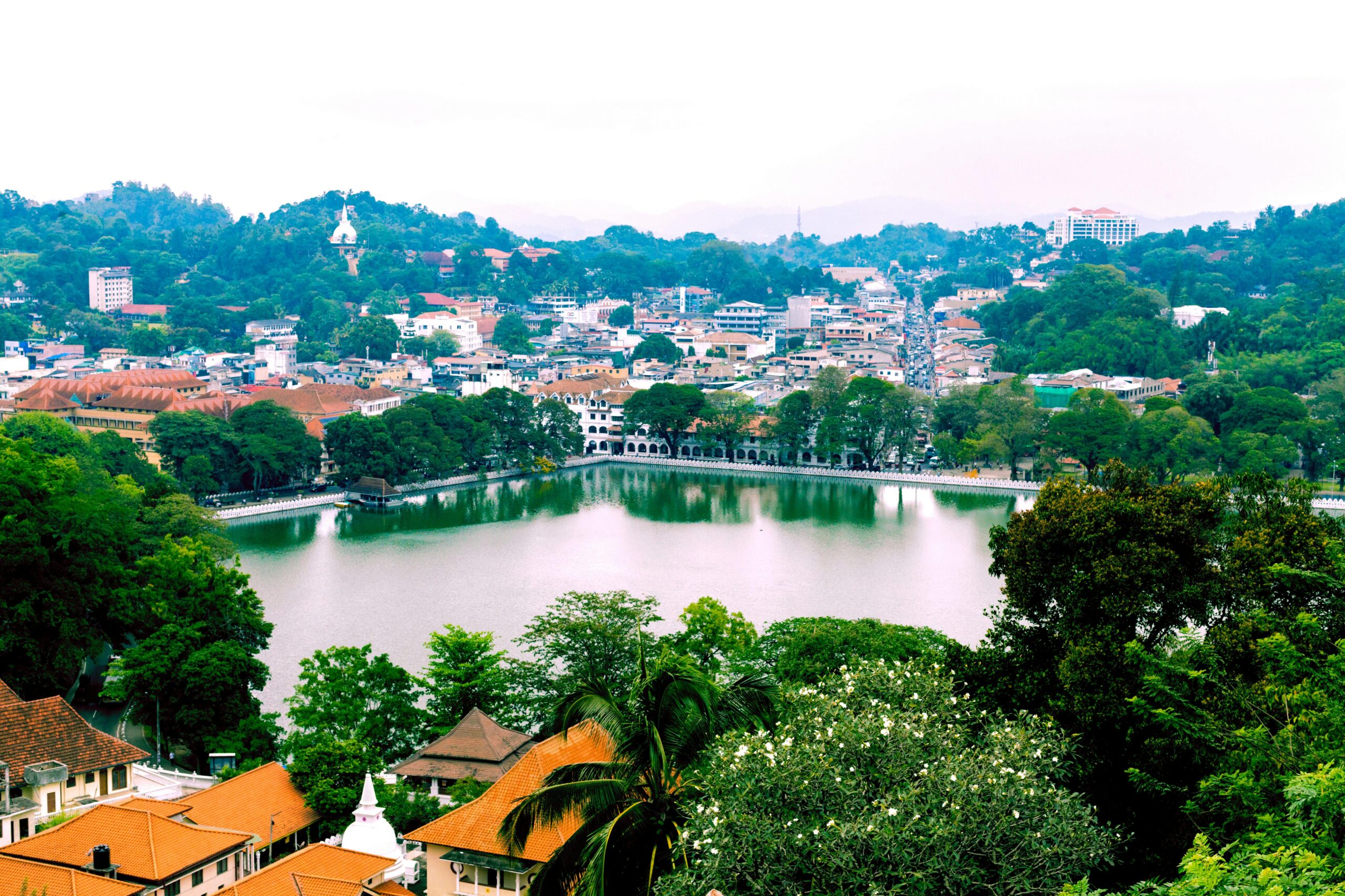 a lake surrounded by trees and buildings